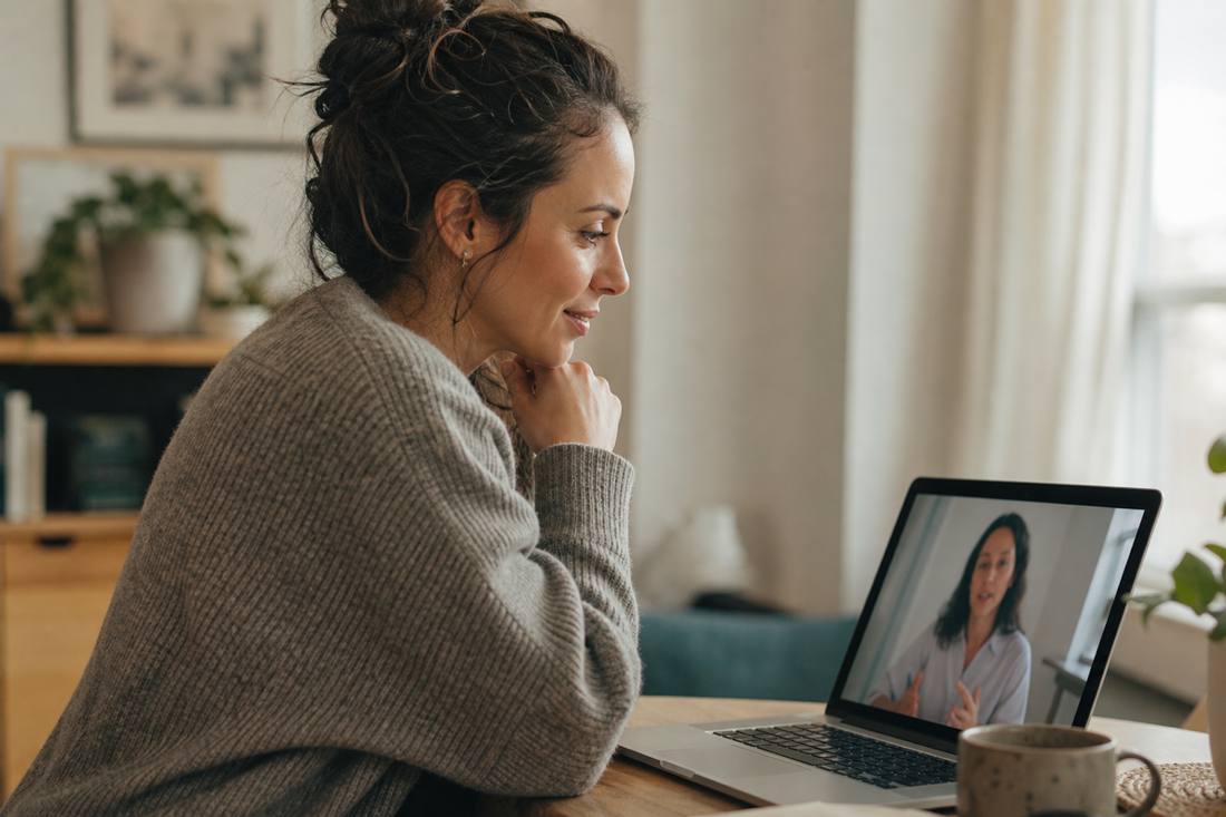 Adult on a quiet phone call at home, looking relieved after finally being taken seriously.